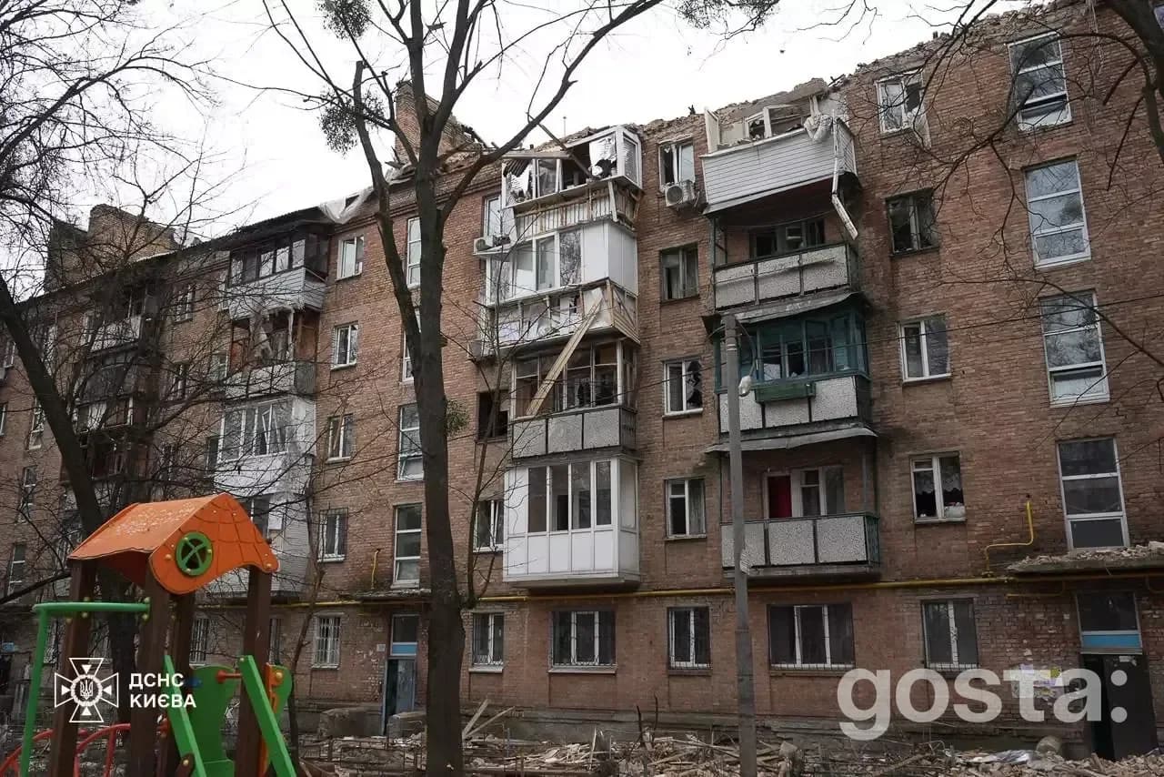 Destruction of residential building in Kyiv after Russian attacks, showing damaged balconies and debris from the impact.