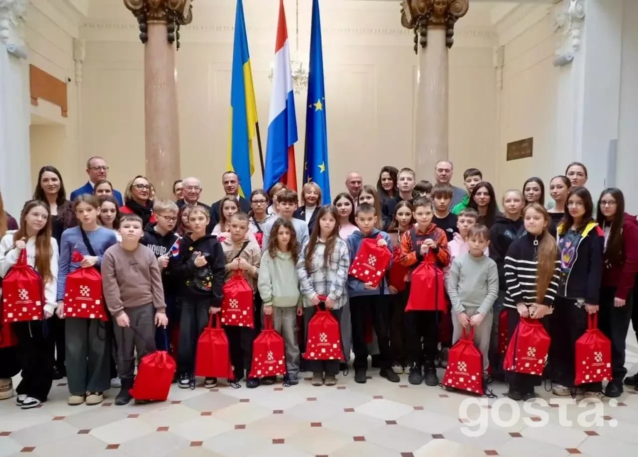 На фото група дітей та дорослих з подарунками у Хорватії, прапори України та Хорватії.