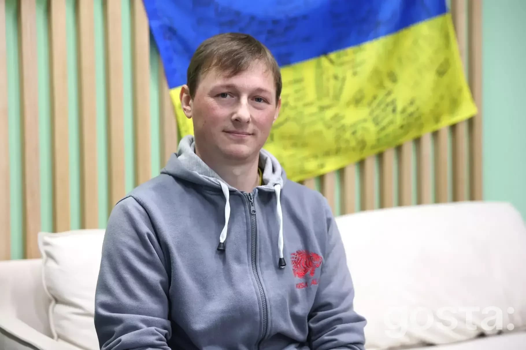 Portrait of a soldier from the National Guard of Ukraine, sharing his story amidst a backdrop of national pride.