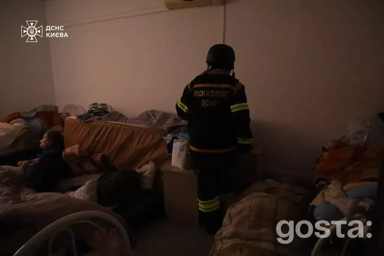 Rescuers from the State Emergency Service of Ukraine assess damage after a Russian attack, aiding injured citizens.