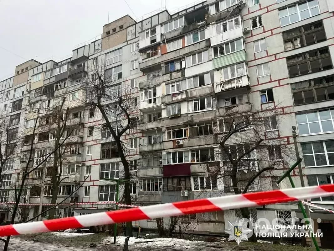 Severely damaged apartment building in Dnipro following a Russian attack, with emergency services present for assistance