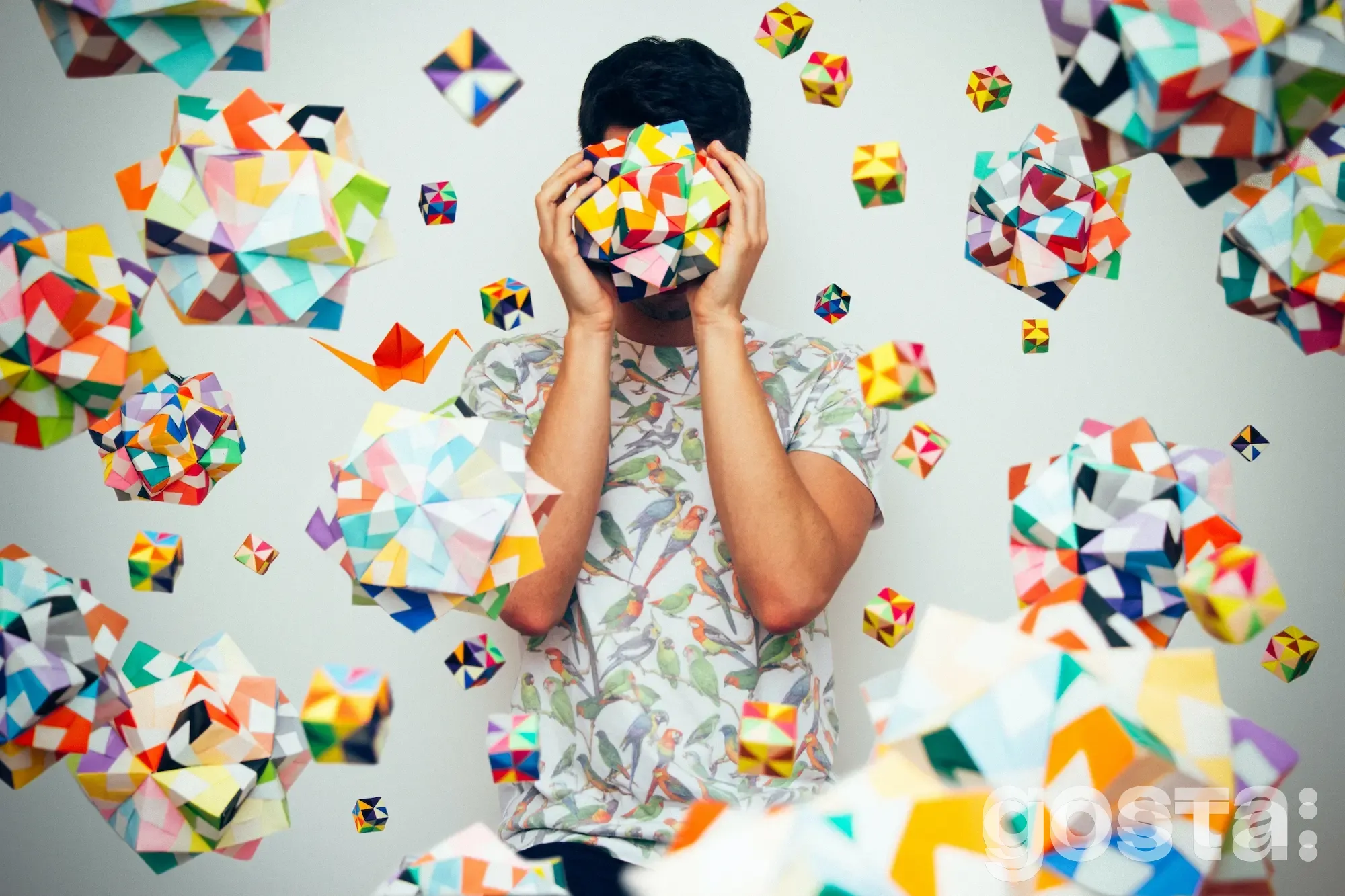 Орігамі – це: мистецтво із паперу – чоловік тримає в руках кульку орігамі