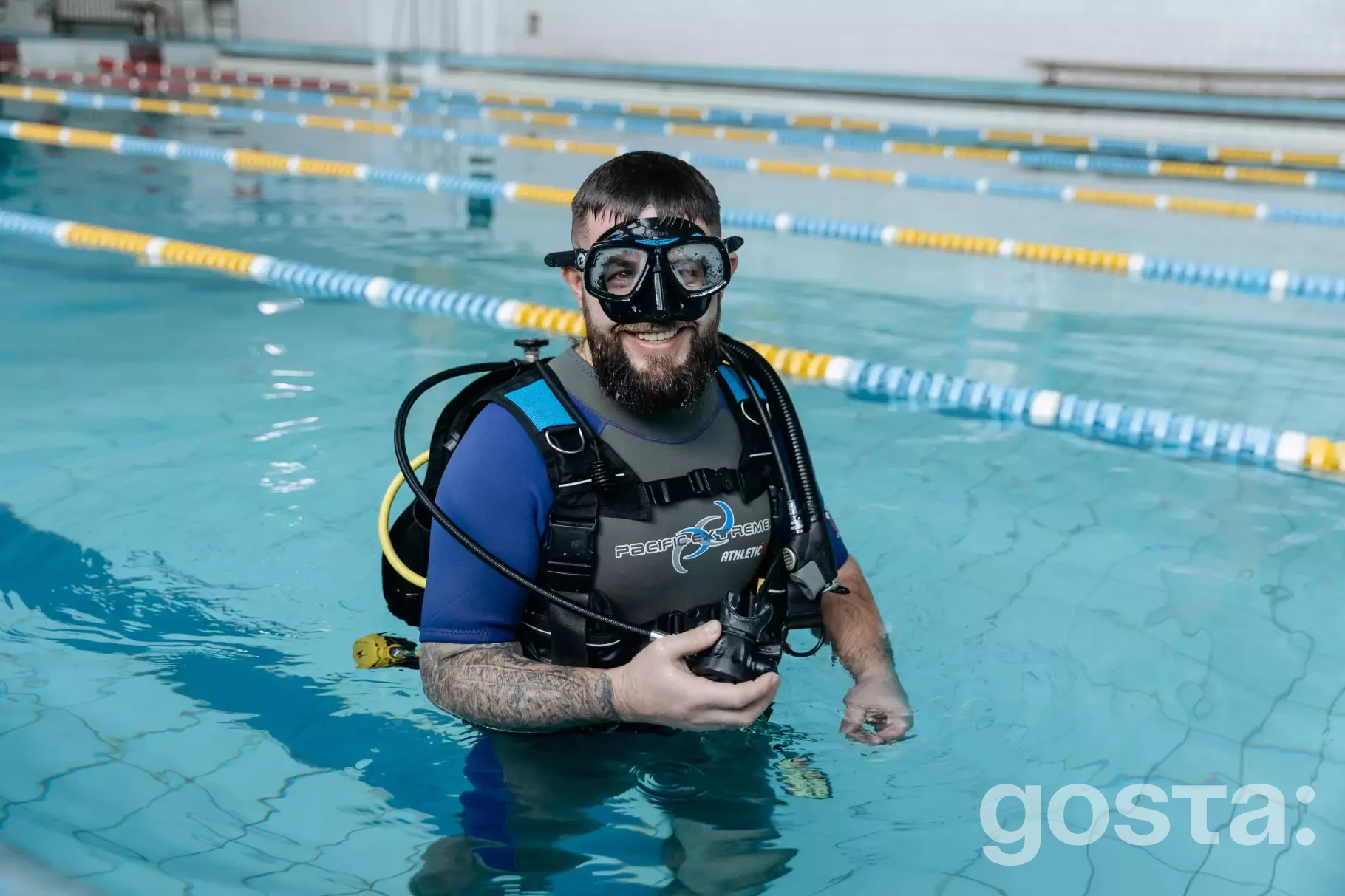 Дайвінг для реабілітації поранених ветеранів у басейні; учасник з обладнанням у воді.