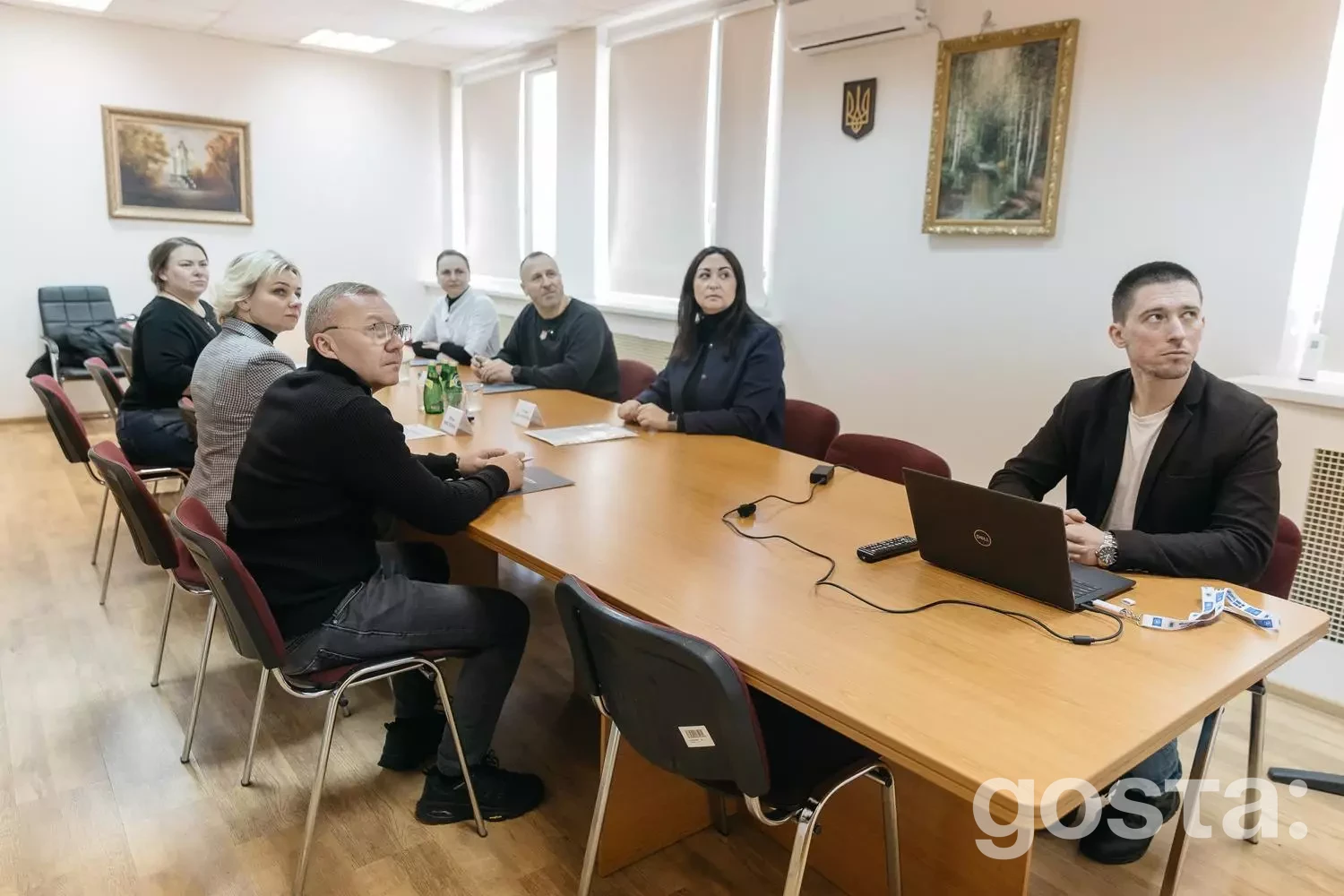 Люди на зустрічі в медичному центрі обговорюють реабілітацію ветеранів МВС з використанням сучасних технологій.